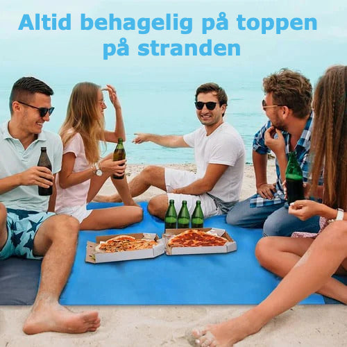 Multifunktionelt strandhåndklæde